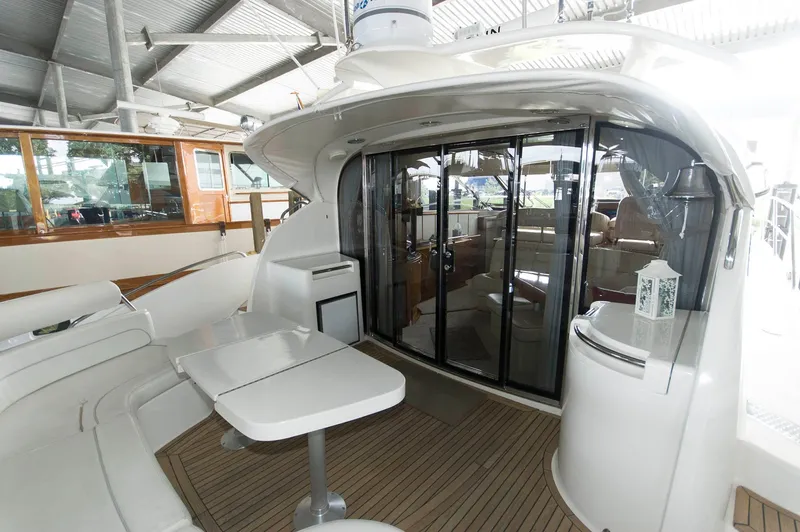 Slide: The Image of 2001 Neptunus 56 Express yacht interior with seating and sliding glass doors. - 5