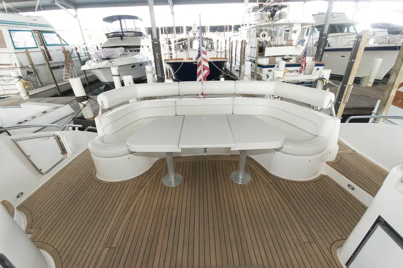 Slide: The Image of Luxury Neptunus 56 Express yacht deck with seating, 2001 model, docked in marina. - 7