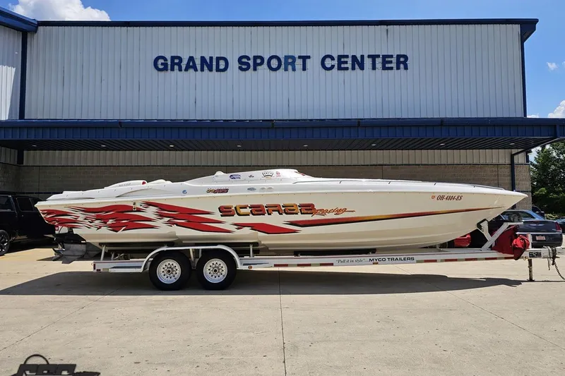 The Image of 2001 Wellcraft 33 Scarab AVS boat on trailer at Grand Sport Center. - 1