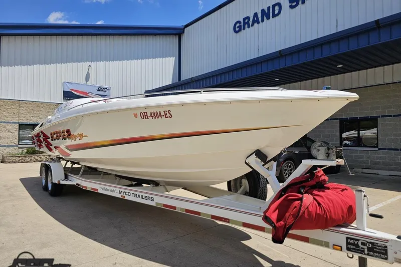 Slide: The Image of 2001 Wellcraft 33 Scarab AVS boat on trailer outside Grand Sport Center. - 14