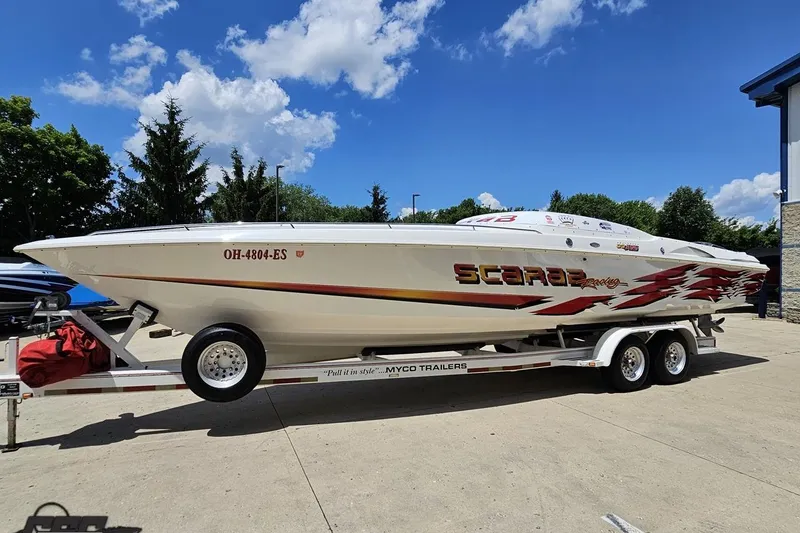 Slide: The Image of 2001 Wellcraft 33 Scarab AVS boat on trailer under blue sky. - 18