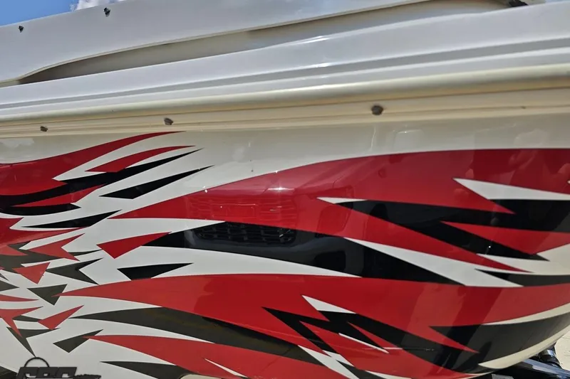 Slide: The Image of 2001 Wellcraft 33 Scarab AVS boat with dynamic red, black, and white graphics. - 29