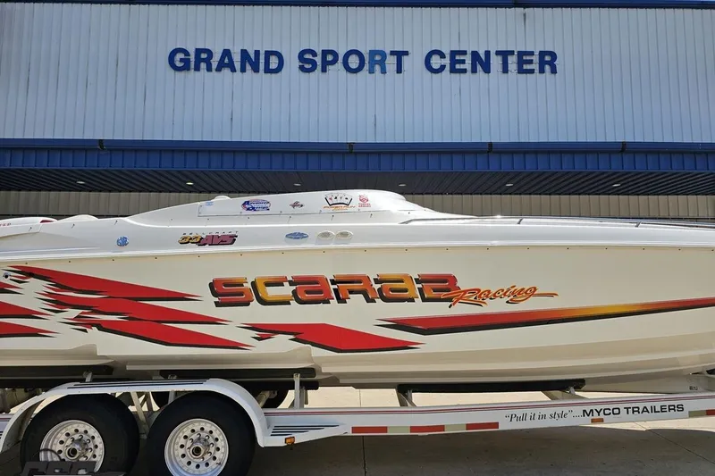 Slide: The Image of 2001 Wellcraft 33 Scarab AVS boat at Grand Sport Center, on trailer. - 3