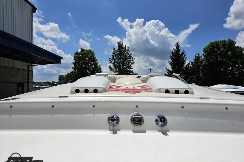 Slide: The Image of 2001 Wellcraft 33 Scarab AVS boat under a blue sky with clouds. - 34