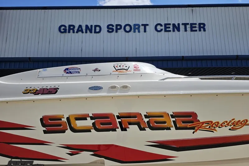 Slide: The Image of 2001 Wellcraft 33 Scarab AVS boat at Grand Sport Center, showcasing racing design. - 4