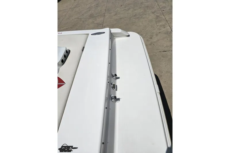 Slide: The Image of 2001 Wellcraft 33 Scarab AVS boat deck, featuring sleek white design and hardware. - 40