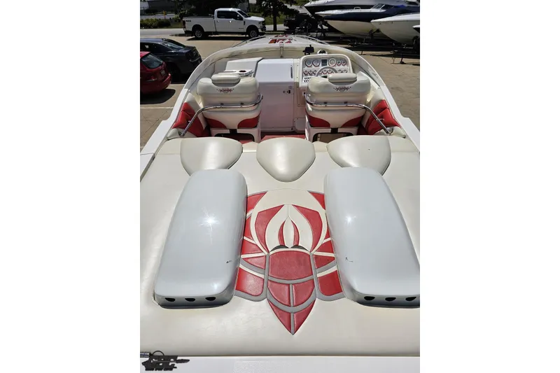 Slide: The Image of 2001 Wellcraft 33 Scarab AVS boat interior with red and white seating and dashboard. - 44