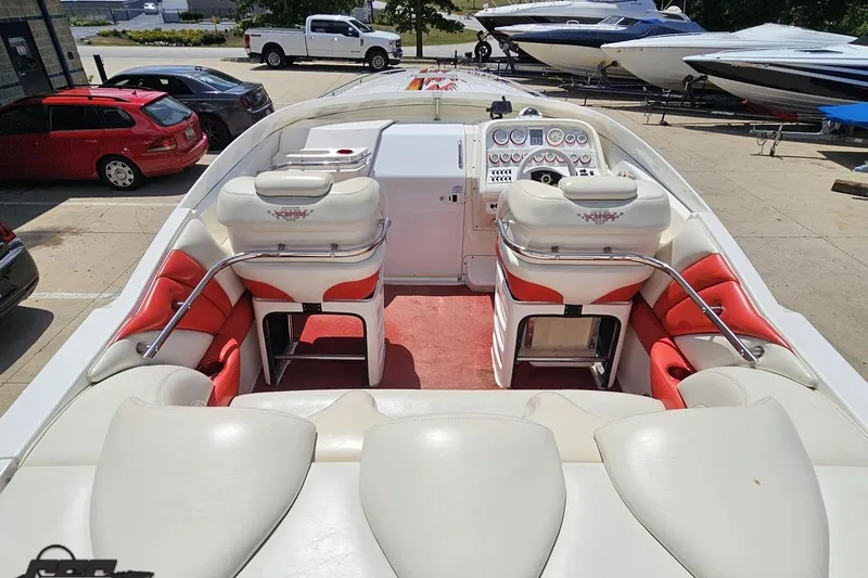 Slide: The Image of 2001 Wellcraft 33 Scarab AVS boat interior with red and white seating, docked outdoors. - 46