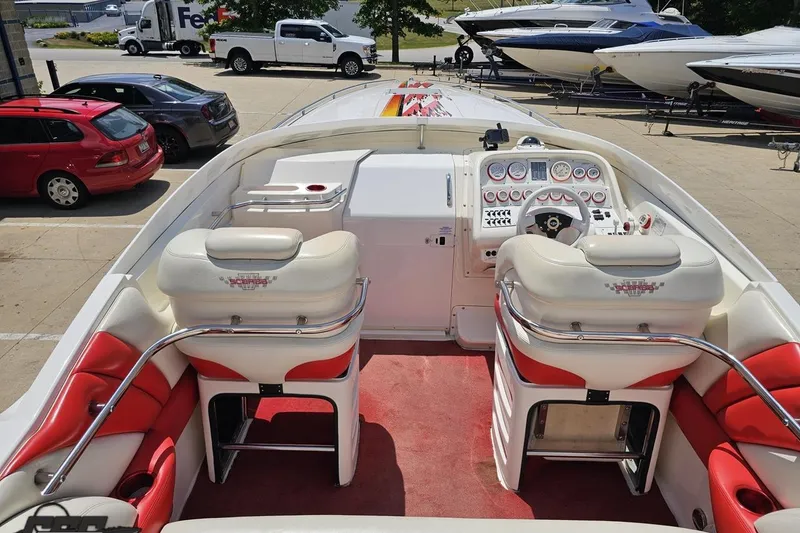 Slide: The Image of 2001 Wellcraft 33 Scarab AVS boat interior with red and white seating, dashboard, and steering wheel. - 47