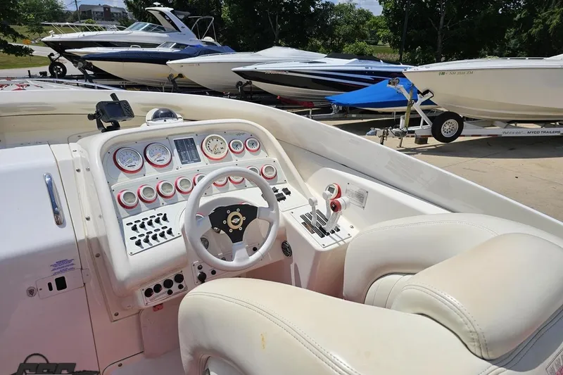 Slide: The Image of 2001 Wellcraft 33 Scarab AVS boat interior with steering wheel and control panel. - 51
