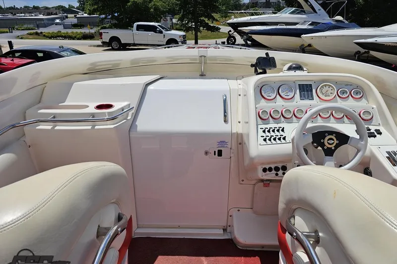 Slide: The Image of 2001 Wellcraft 33 Scarab AVS boat dashboard with gauges and steering wheel. - 52