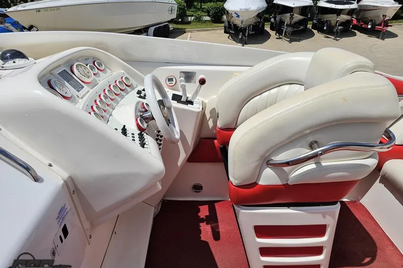 Slide: The Image of 2001 Wellcraft 33 Scarab AVS boat interior with white and red seating, dashboard controls. - 58
