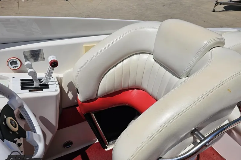 Slide: The Image of 2001 Wellcraft 33 Scarab AVS cockpit with white and red seating, steering wheel, and controls. - 59