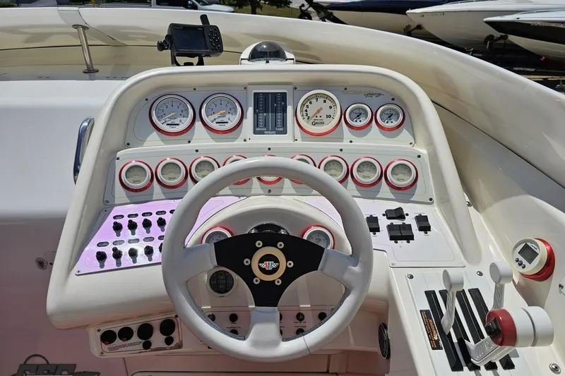 Slide: The Image of Dashboard of a 2001 Wellcraft 33 Scarab AVS boat with gauges and controls. - 61