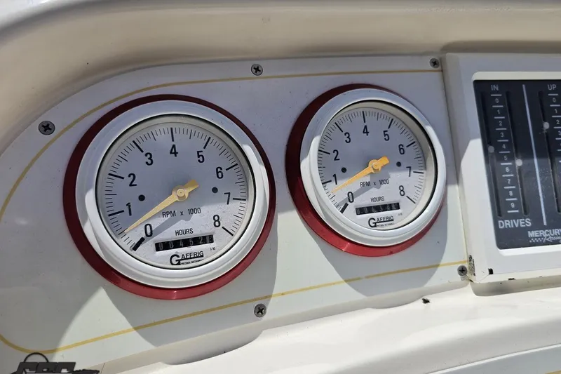 Slide: The Image of Dashboard gauges of 2001 Wellcraft 33 Scarab AVS boat, showing RPM and hours. - 63