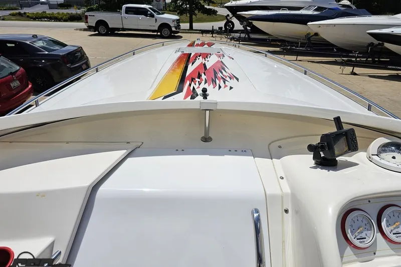 Slide: The Image of 2001 Wellcraft 33 Scarab AVS boat with vibrant deck design and dashboard instruments. - 64