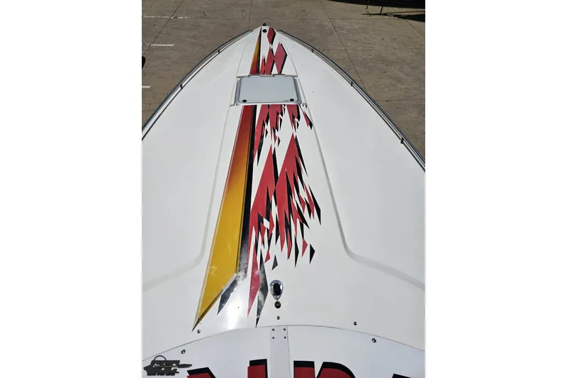 Slide: The Image of 2001 Wellcraft 33 Scarab AVS boat with vibrant red and yellow graphics on deck. - 67