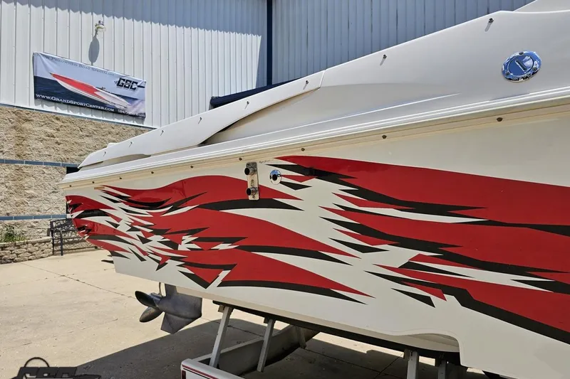 Slide: The Image of 2001 Wellcraft 33 Scarab AVS boat with bold red and black graphics on the hull. - 7