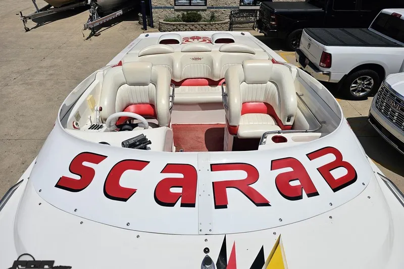 Slide: The Image of 2001 Wellcraft 33 Scarab AVS boat with white and red interior, parked outdoors. - 72