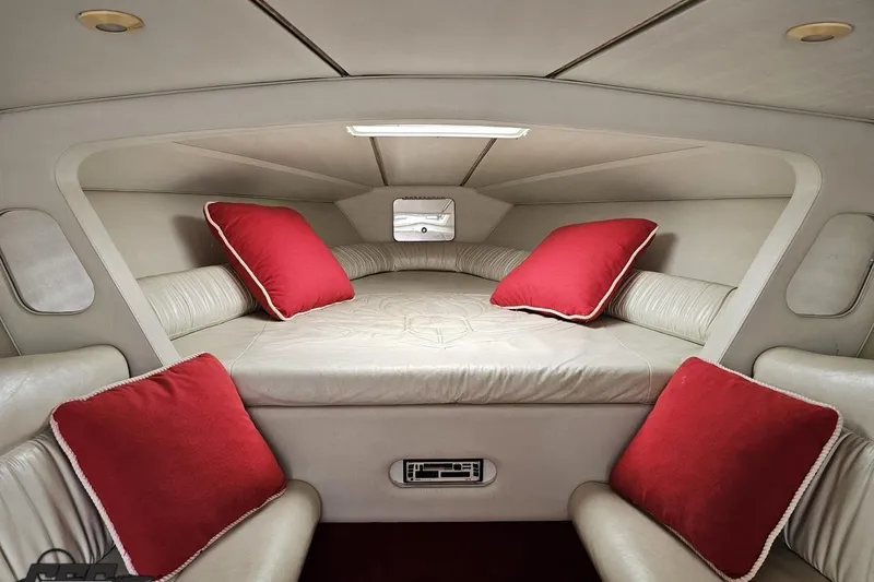 Slide: The Image of Interior cabin of 2001 Wellcraft 33 Scarab AVS with red cushions and beige seating. - 76