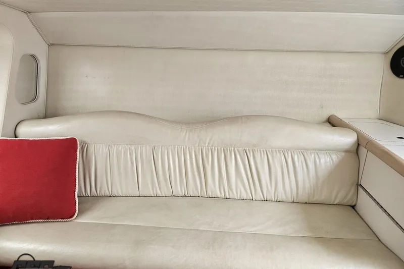 Slide: The Image of Interior of 2001 Wellcraft 33 Scarab AVS with white leather seating and red cushion. - 78