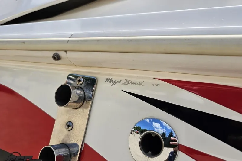 Slide: The Image of Close-up of 2001 Wellcraft 33 Scarab AVS boat detailing with red and black accents. - 8