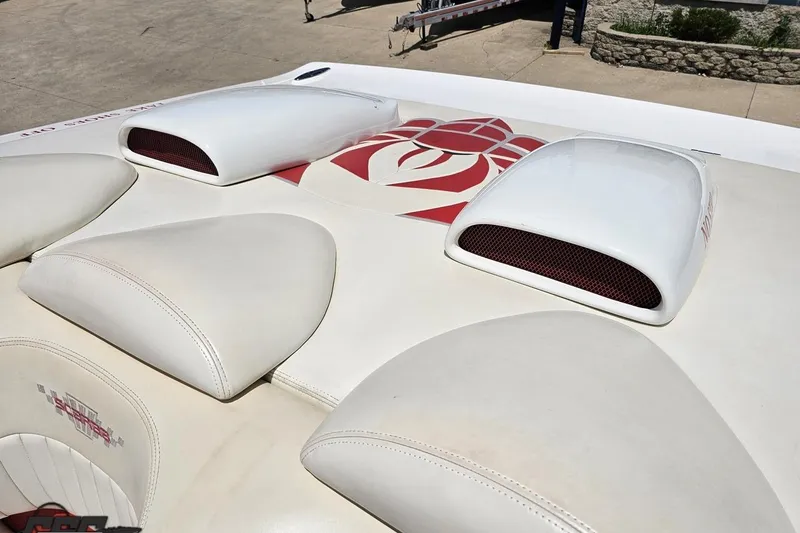 Slide: The Image of 2001 Wellcraft 33 Scarab AVS boat with white upholstery and red design accents. - 89