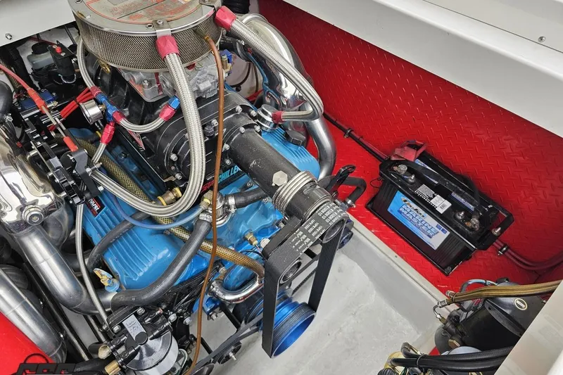 Slide: The Image of Engine compartment of 2001 Wellcraft 33 Scarab AVS with visible battery and components. - 94