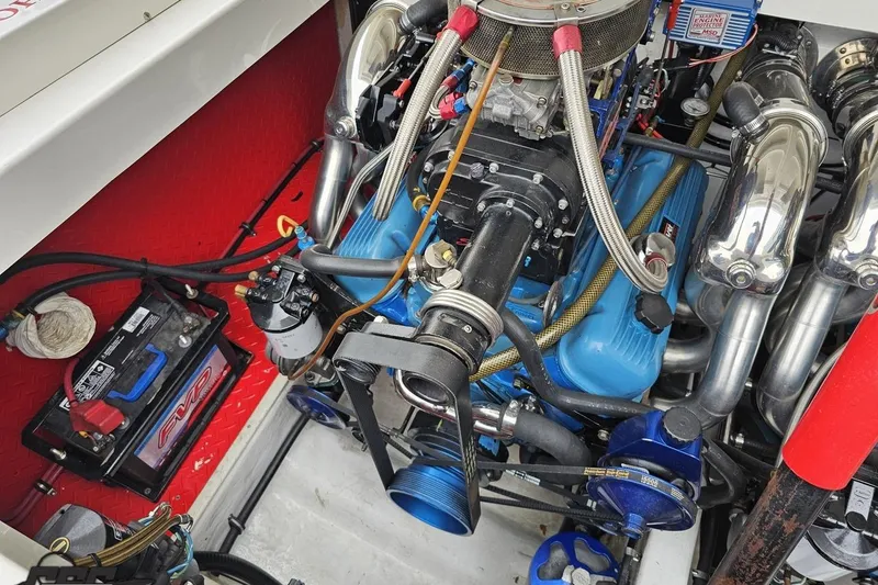 Slide: The Image of Engine compartment of 2001 Wellcraft 33 Scarab AVS with visible components and battery. - 96