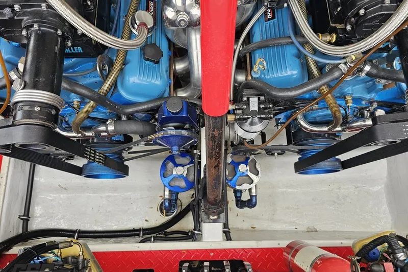 Slide: The Image of Engine compartment of 2001 Wellcraft 33 Scarab AVS with visible blue engine components. - 98