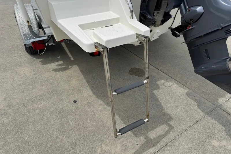 Slide: The Image of 2016 Sea Born SV19 Bay boat with ladder and motor on trailer. - 10