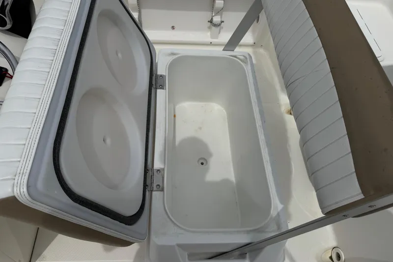 Slide: The Image of Open storage compartment on 2016 Sea Born SV19 Bay boat, featuring cushioned seating. - 17