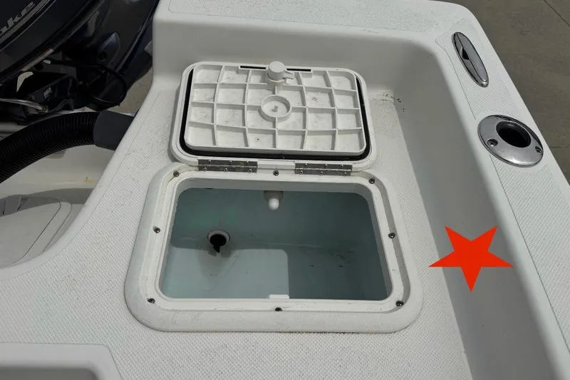 Slide: The Image of Open storage compartment on a 2016 Sea Born SV19 Bay boat deck. - 18