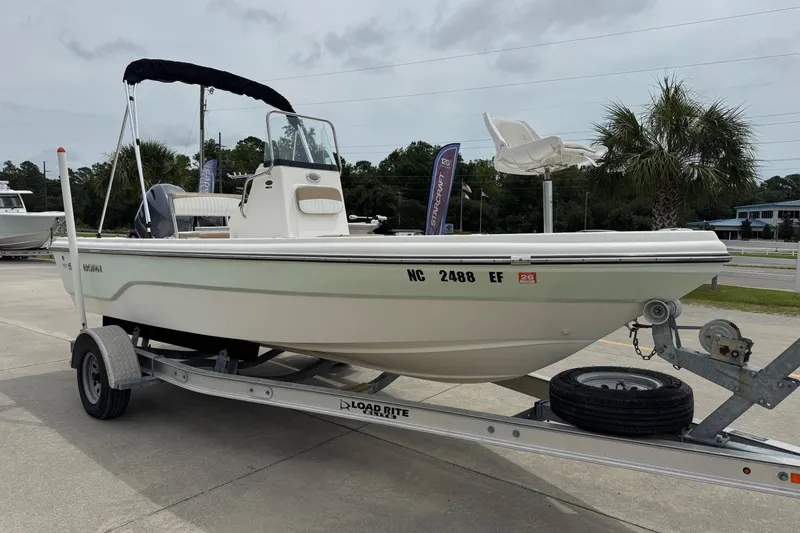 Slide: The Image of 2016 Sea Born SV19 Bay boat on trailer, parked outdoors with palm trees in background. - 5
