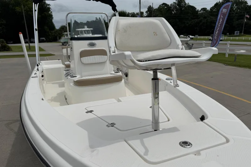 Slide: The Image of 2016 Sea Born SV19 Bay boat with white seating and console, parked outdoors. - 6