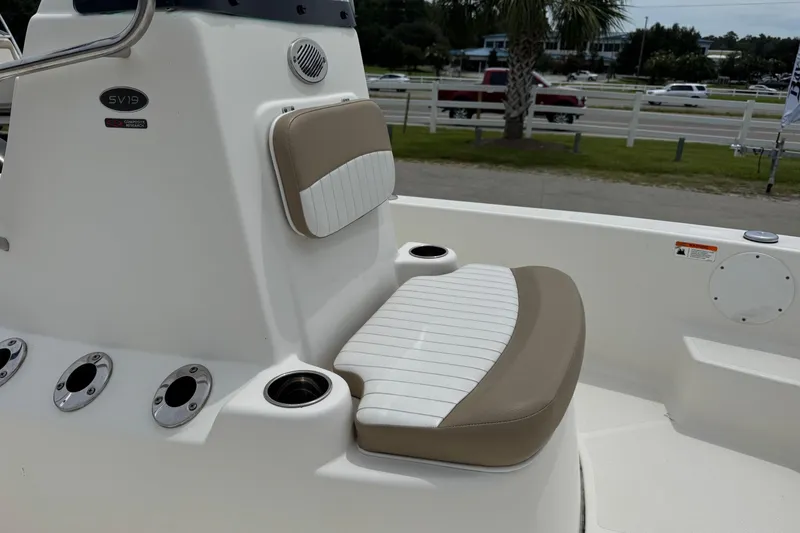 Slide: The Image of 2016 Sea Born SV19 Bay boat interior with cushioned seating and cup holders. - 7