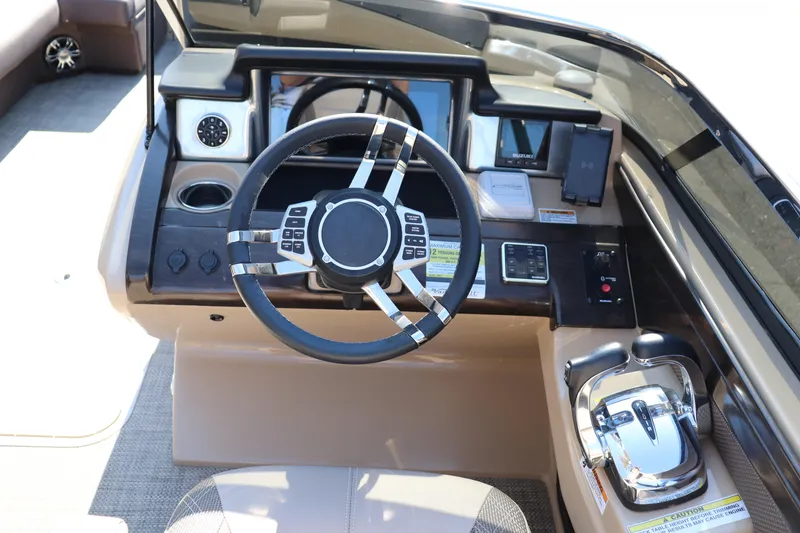 Slide: The Image of 2023 Vanderbilt 700 Twin boat dashboard with steering wheel and controls. - 7