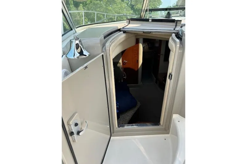 Slide: The Image of 2005 Sea Ray 390 Sundancer cabin entrance with open door, showcasing interior details. - 16