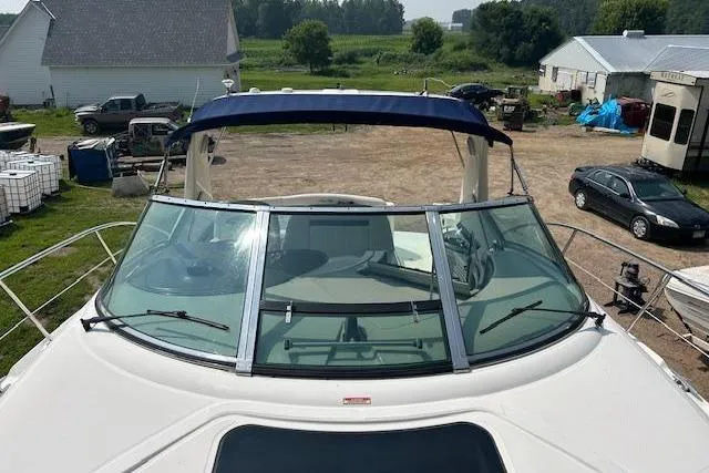 Slide: The Image of 2005 Sea Ray 390 Sundancer boat with blue canopy, parked outdoors. - 5