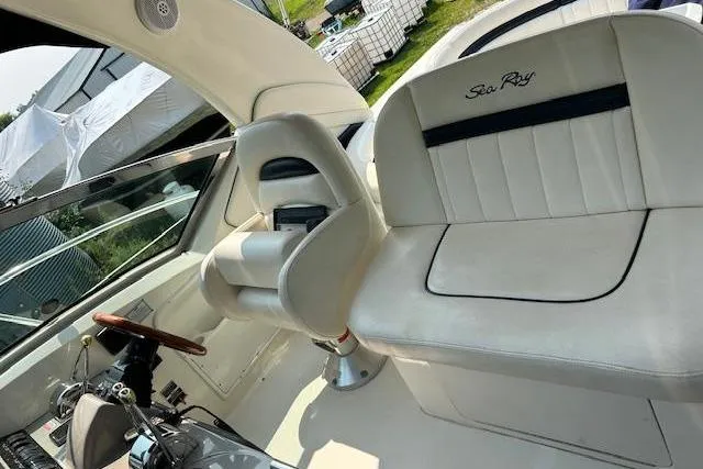 Slide: The Image of 2005 Sea Ray 390 Sundancer cockpit with white leather seating and steering wheel. - 8