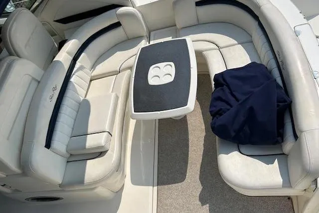Slide: The Image of 2005 Sea Ray 390 Sundancer interior with white seating and central table. - 9