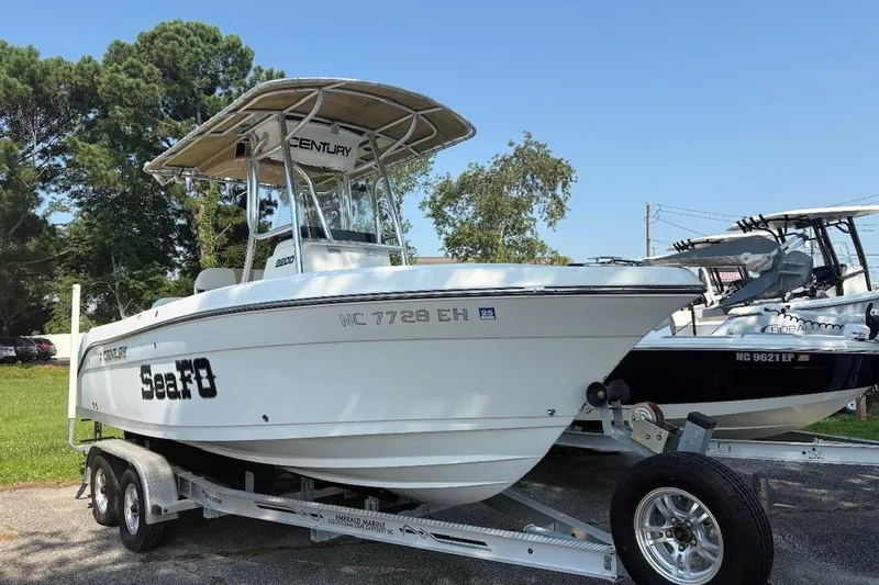 The Image of 2017 Century 2200 Center Console boat on trailer, parked outdoors. - 0