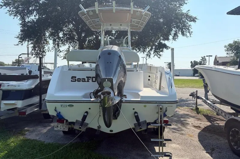 Slide: The Image of 2017 Century 2200 Center Console boat with outboard motor, parked outdoors. - 2