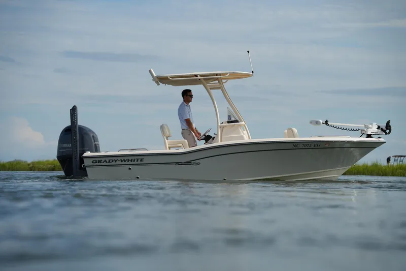 Slide: The Image of 2018 Grady-White 191 Coastal Explorer boat on water, side view, with person onboard. - 12