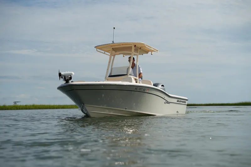 Slide: The Image of 2018 Grady-White 191 Coastal Explorer boat on calm water, under a clear sky. - 16