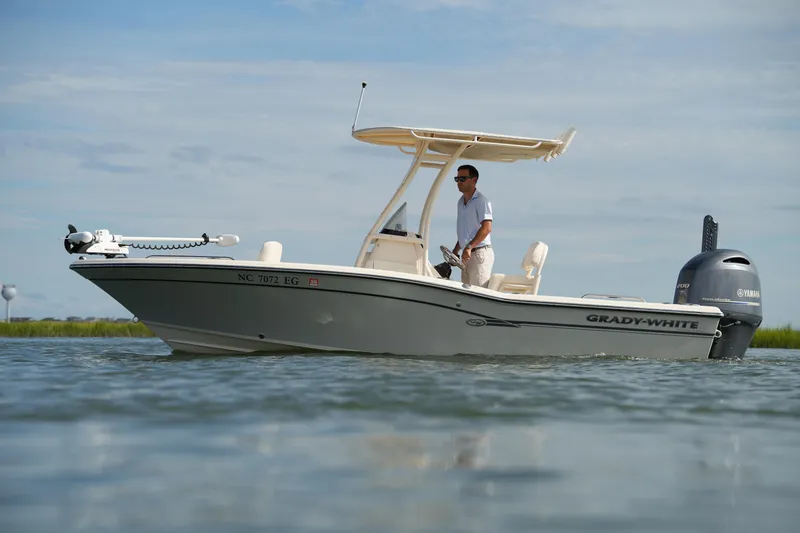 Slide: The Image of 2018 Grady-White 191 Coastal Explorer boat on water with person steering. - 2