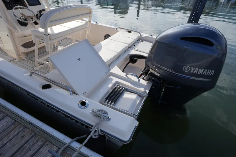 Slide: The Image of 2018 Grady-White 191 Coastal Explorer with Yamaha outboard engine, docked by the water. - 21