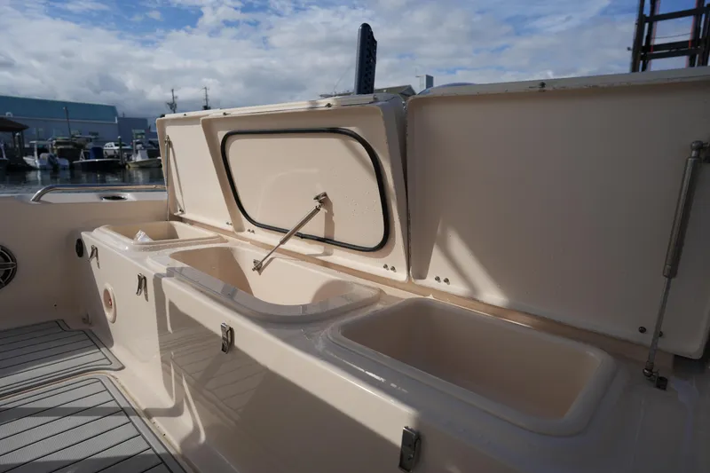 Slide: The Image of 2018 Grady-White 191 Coastal Explorer boat interior with open storage compartments. - 24