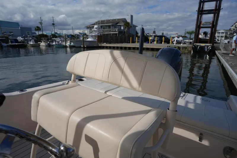 Slide: The Image of 2018 Grady-White 191 Coastal Explorer boat seat at marina, under cloudy sky. - 26
