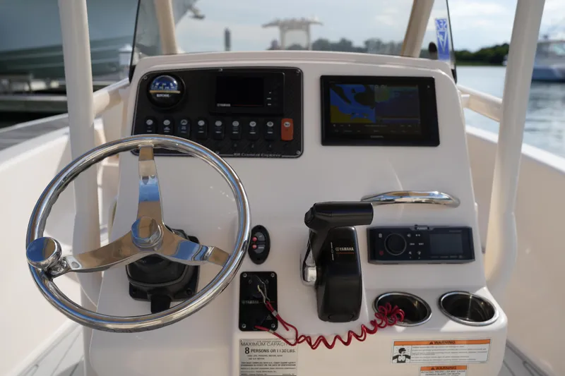 Slide: The Image of 2018 Grady-White 191 Coastal Explorer boat dashboard with steering wheel and navigation controls. - 27